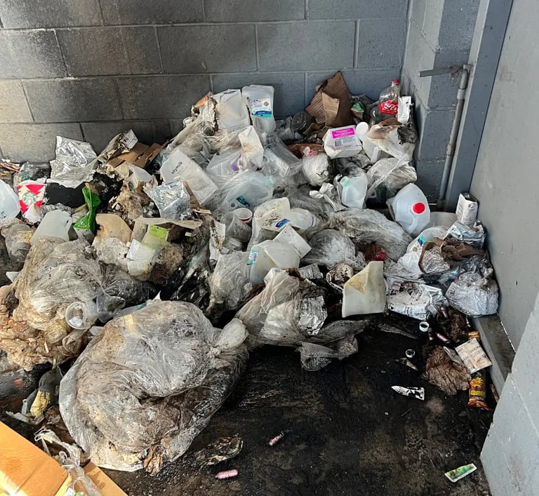 pile of trash in garbage enclosure