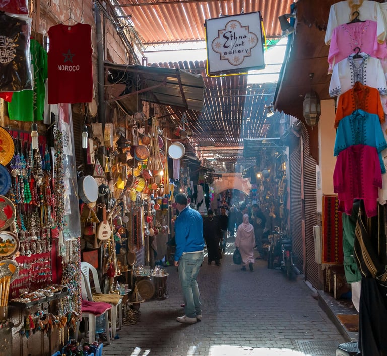 Moroccan traditional market in Marrakech with locals and spices