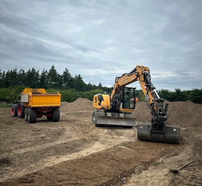 a tractor with a dump truck behind it