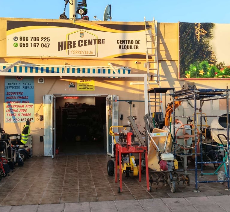Torrevieja hire centre storefront displaying mobility scooters and construction equipment for rent.