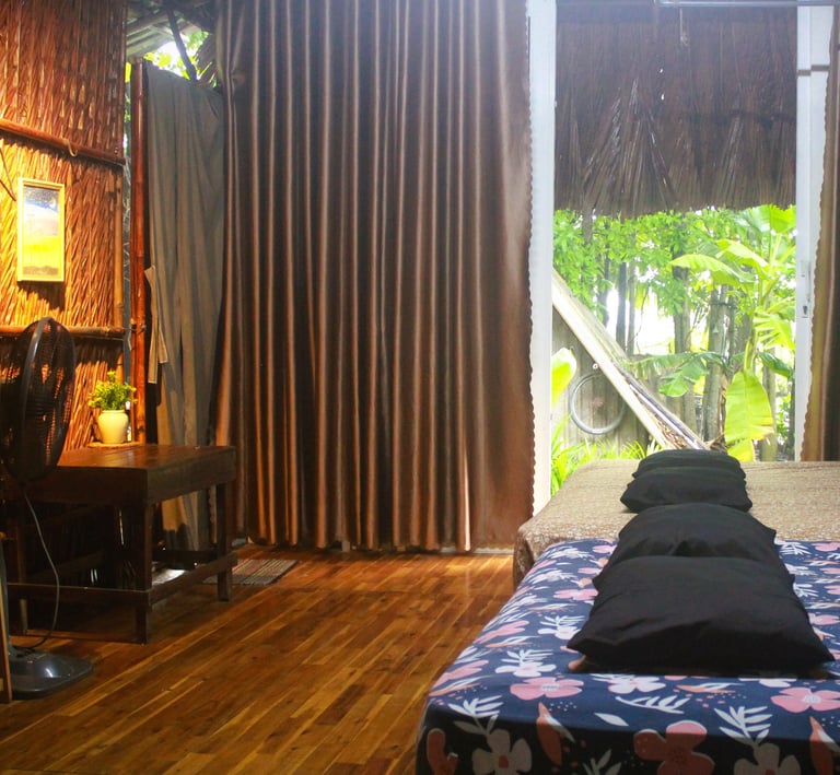 Spacious twin-bed room with large windows overlooking the tropical vegetable garden.
