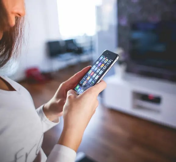 a woman holding a cell phone in her hand
