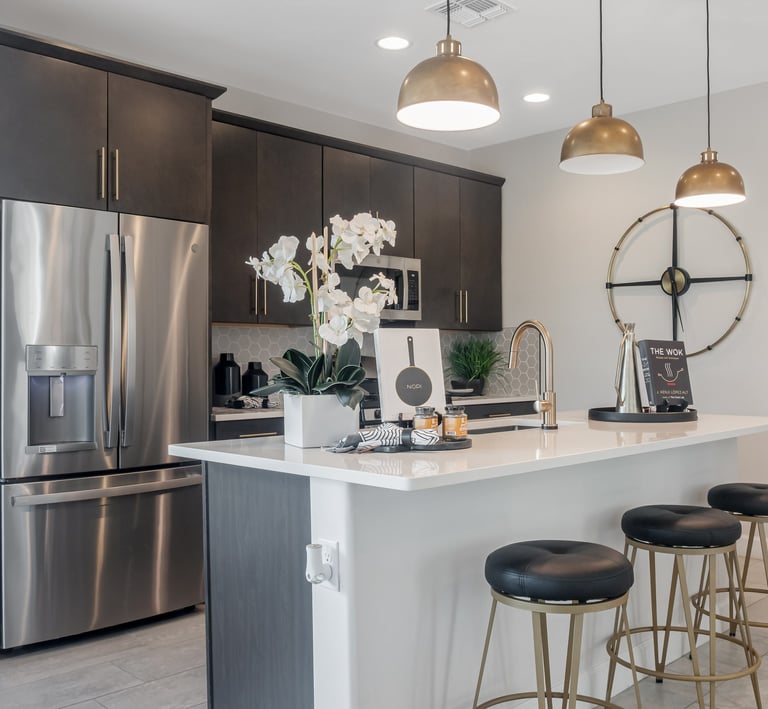 a kitchen with a large island and a bar stool