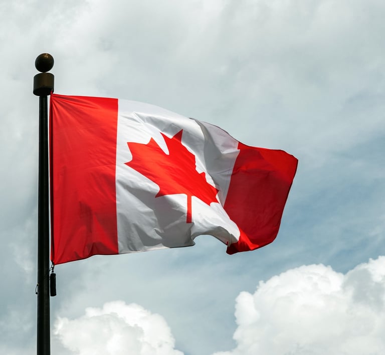 a canadian flag flying in the sky