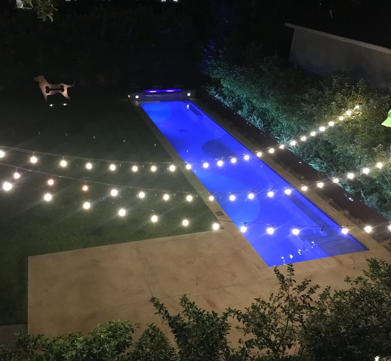 string lighting, strip lighting and accent up lights on statue