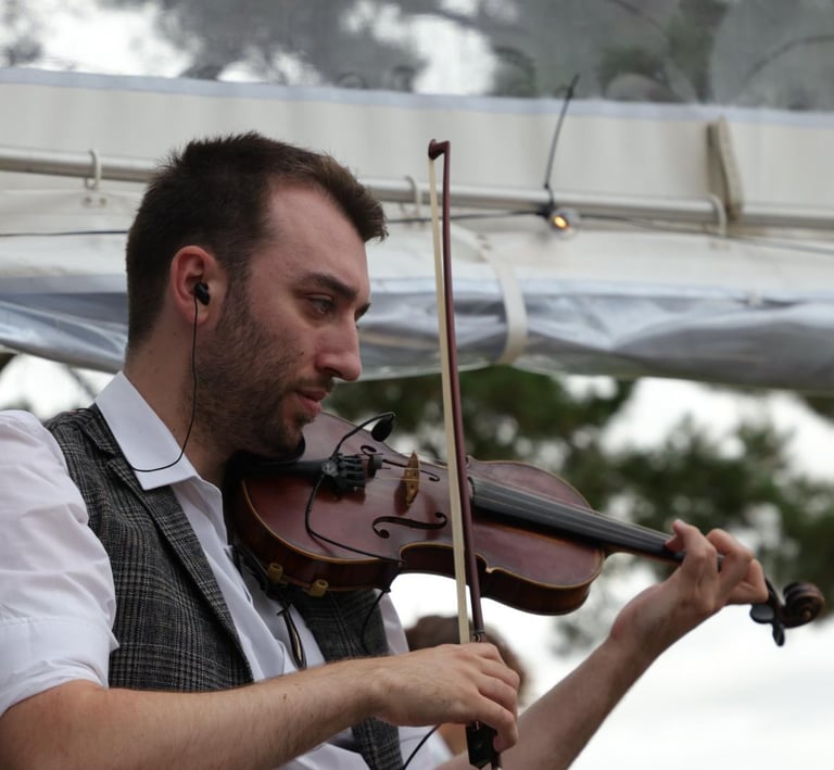 A professional fiddler performing high-energy folk music with Rowans ceilidh band.
