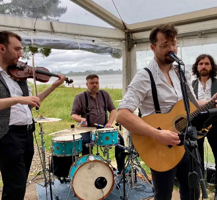 Rowans performing live as a modern wedding ceilidh band with guitar, fiddle, and drums for a packed dancefloor