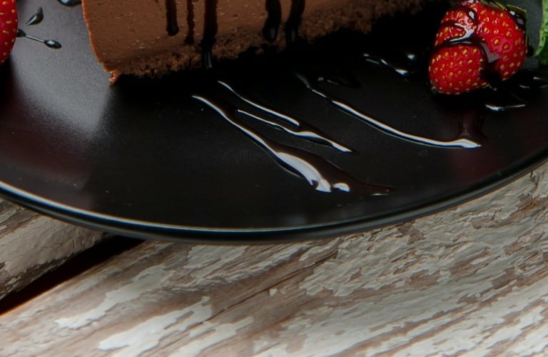 a chocolate cake with strawberries dessert in the restaurant table.Hospitality Startup Guidance