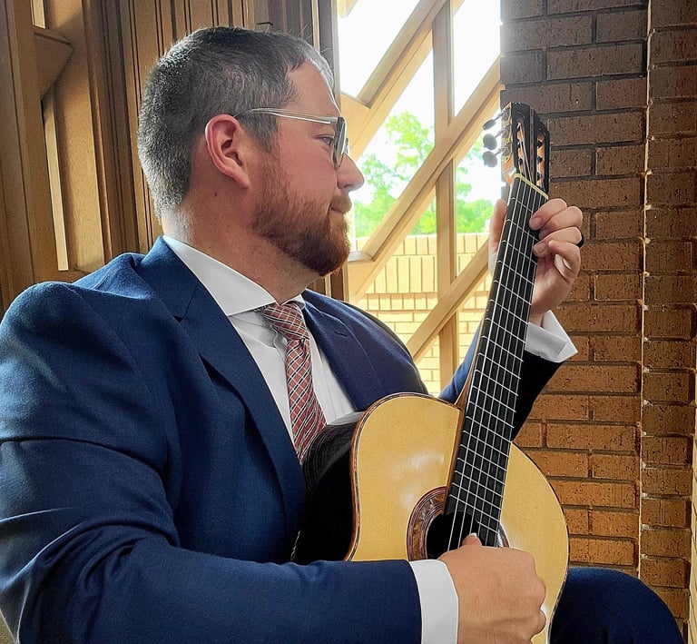 Dan Kyzer playing guitar in blue suit at a wedding in Fort Worth, Texas. 