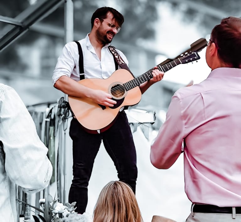 Live acoustic music performance by Rowans at a festival-themed wedding.