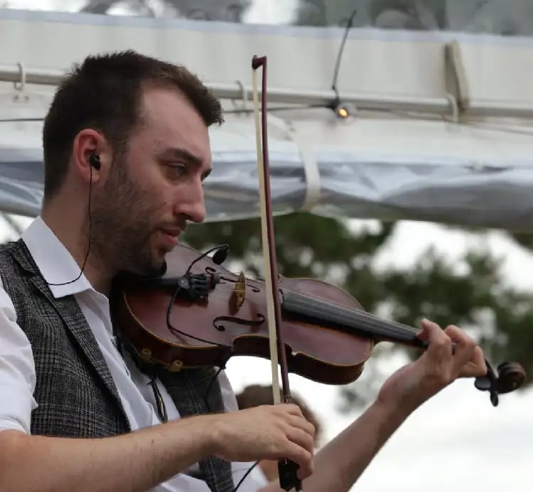 Professional fiddle player performing traditional Irish folk music for a Devon ceilidh band at a wedding