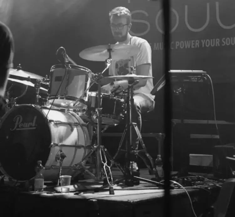 Close-up of Mosaic's drummer performing a high-energy rhythm set at a wedding reception