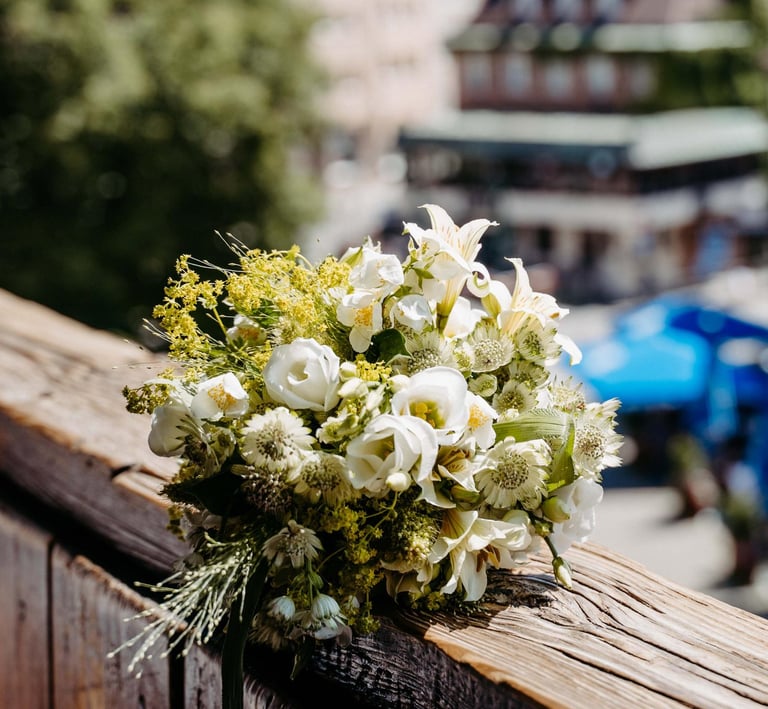 a bouquet of flowers on a wooden fence