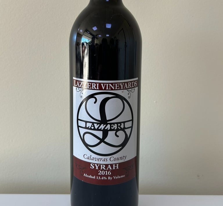 A close up picture of a wine bottle labeled Syrah