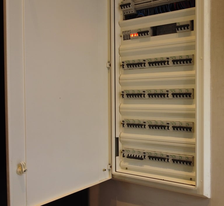 a cabinet with a bunch of electrical equipment in it