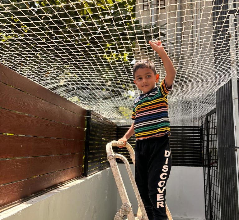 Close-up of a sturdy children safety net securely installed on a balcony railing in Sadashivanagar.