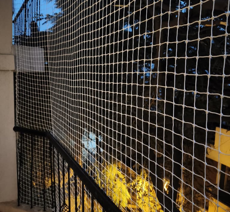 Close-up of a freshly installed balcony safety net in a high-rise apartment in Bengaluru, showing th