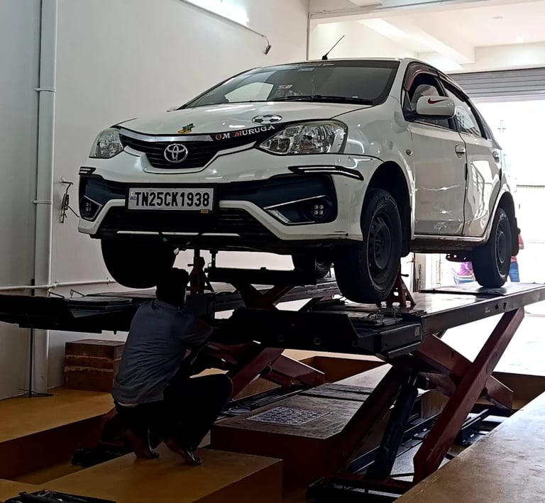 wheel alignment service with car on lift in tyre shop