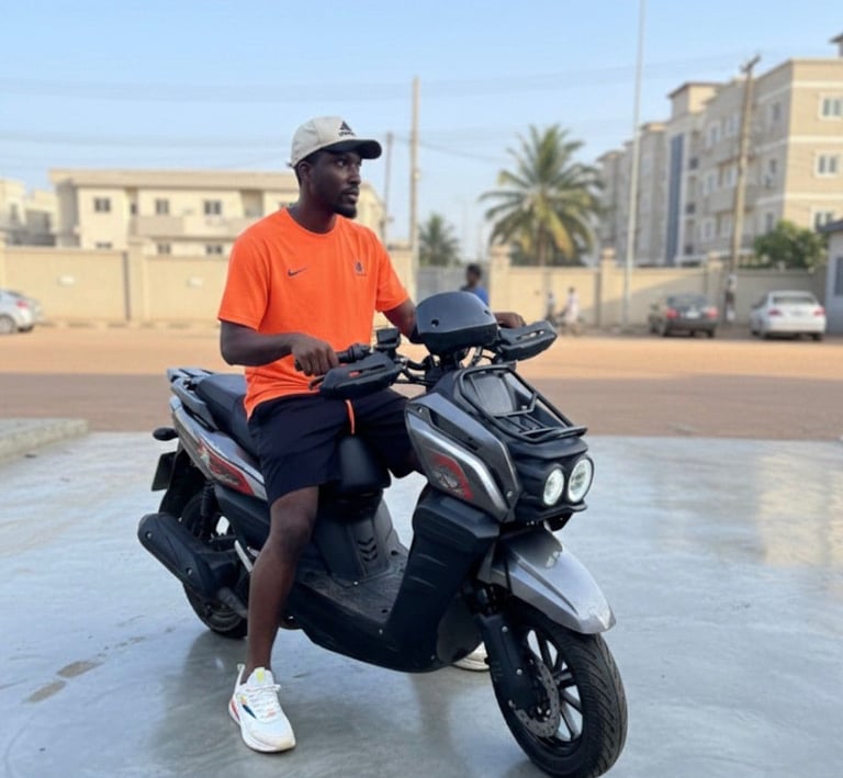 young man on orange tshirt on a gray and black bike