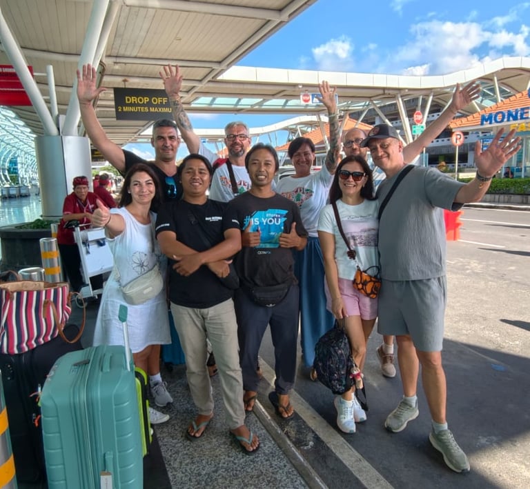 Komang with happy customers at the drop-off area of ​​Ngurah Rai Airport, Bali