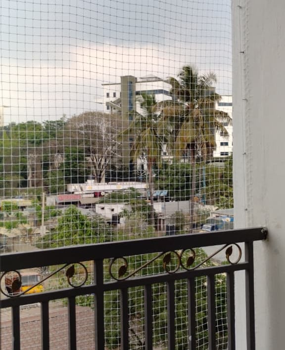 Completed pigeon net installation on a residential balcony, preventing bird entry.