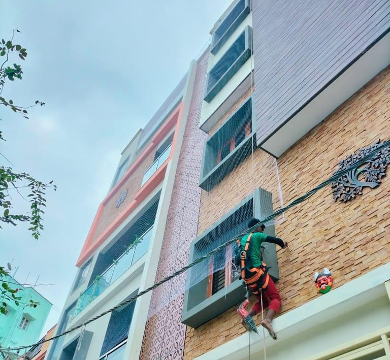 Child playing safely on a balcony protected by a tightly woven safety net installed by Arjilli Enter