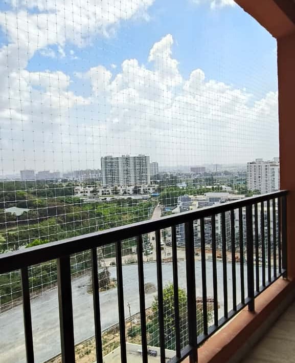 Close-up of a freshly installed pigeon safety net tightly secured on a Kodambakkam balcony.