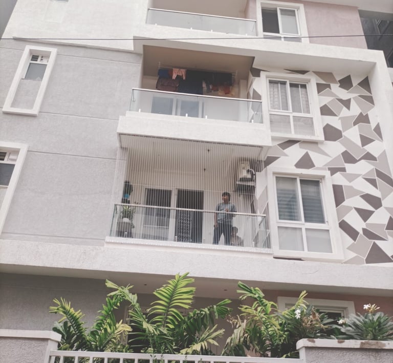 A close-up of a sturdy balcony safety net installed on a high-rise apartment in Chennai.