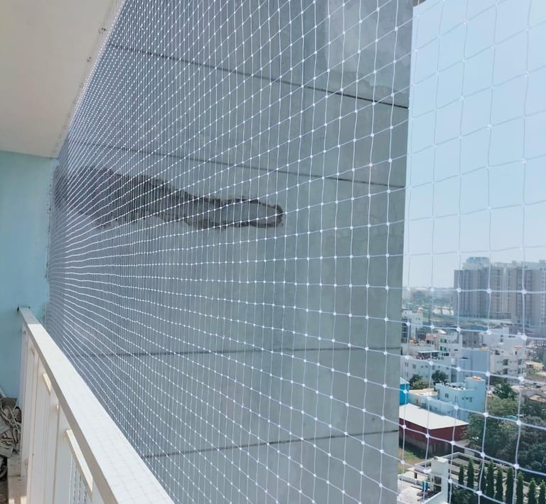 Close-up of a securely installed balcony safety net in a sunny Adyar apartment.