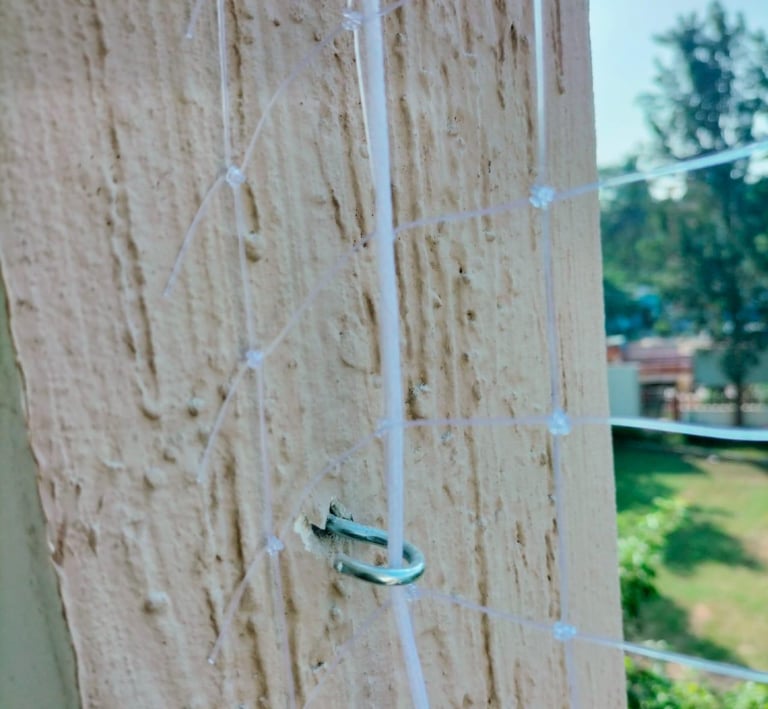 A close-up of a sturdy balcony safety net installed on a high-rise apartment in Chennai.