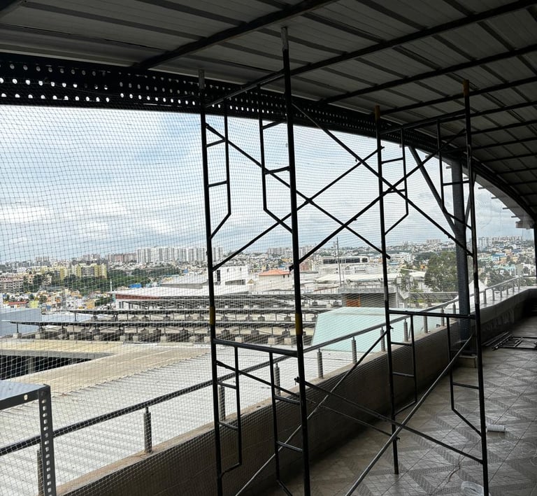 Wide shot of a residential balcony fully covered with a fine mesh pigeon net, blending seamlessly wi