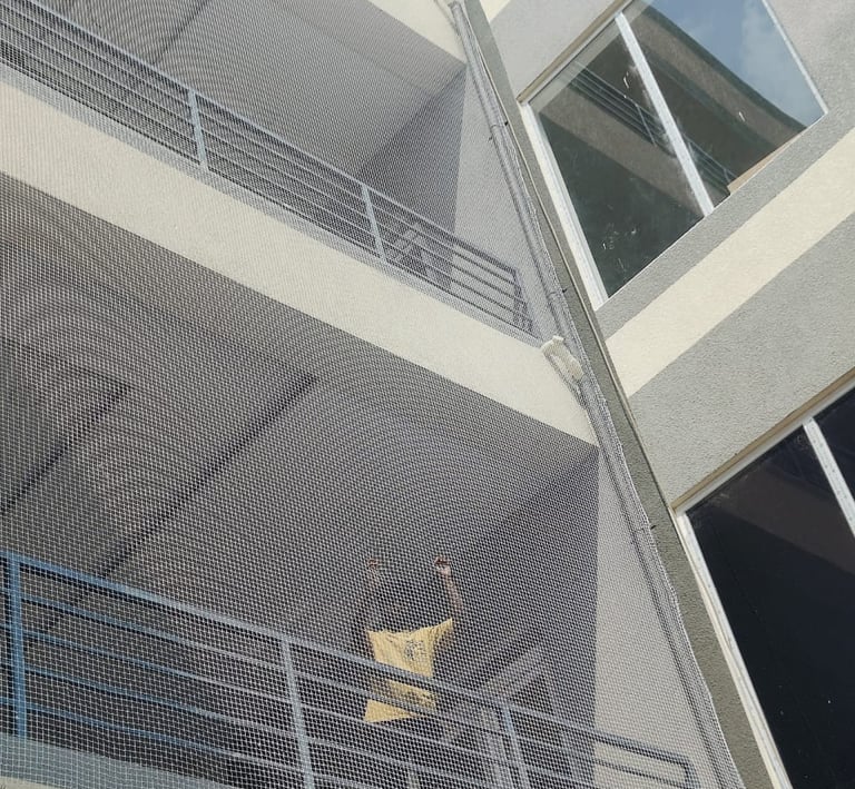 Technician from Arjilli Enterprises fitting the safety net with precision and care.