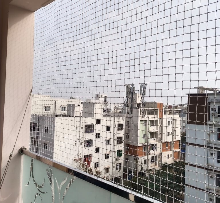 A child playing safely behind a balcony safety net, highlighting the protective barrier in a Velache