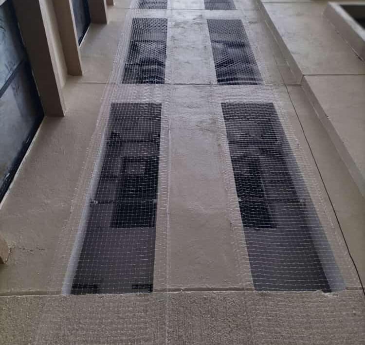 Wide view of a high-rise apartment with pigeon nets securely covering the balconies.