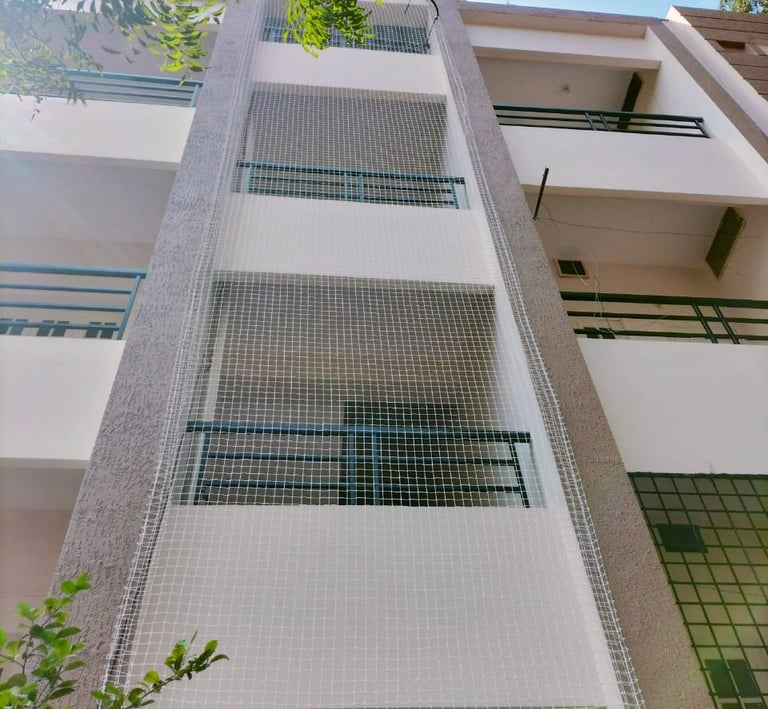Close-up of durable pigeon netting installed on a balcony in OMR, Chennai, showing fine mesh and sec