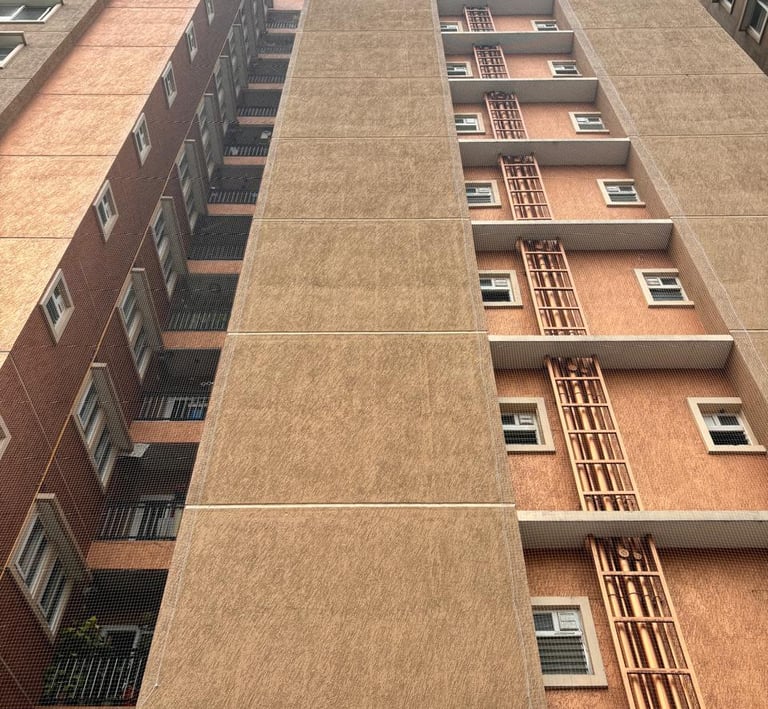 Finished pigeon net installation blending seamlessly with the apartment exterior in Ambattur.