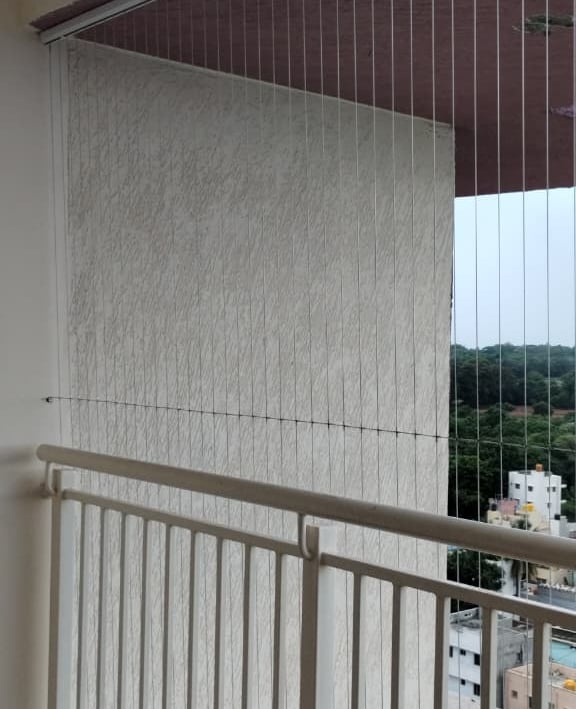 Wide shot of a modern apartment window fitted with invisible grills by Arjilli Enterprises.