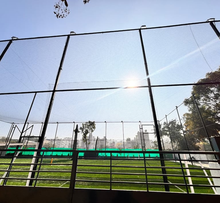 A close-up of sturdy sports nets tightly secured around a vibrant Chennai terrace playground.