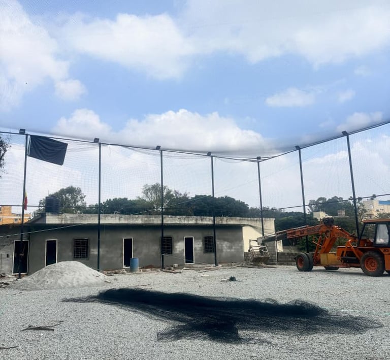 Wide shot showing a spacious playground in Chennai with freshly installed protective nets.