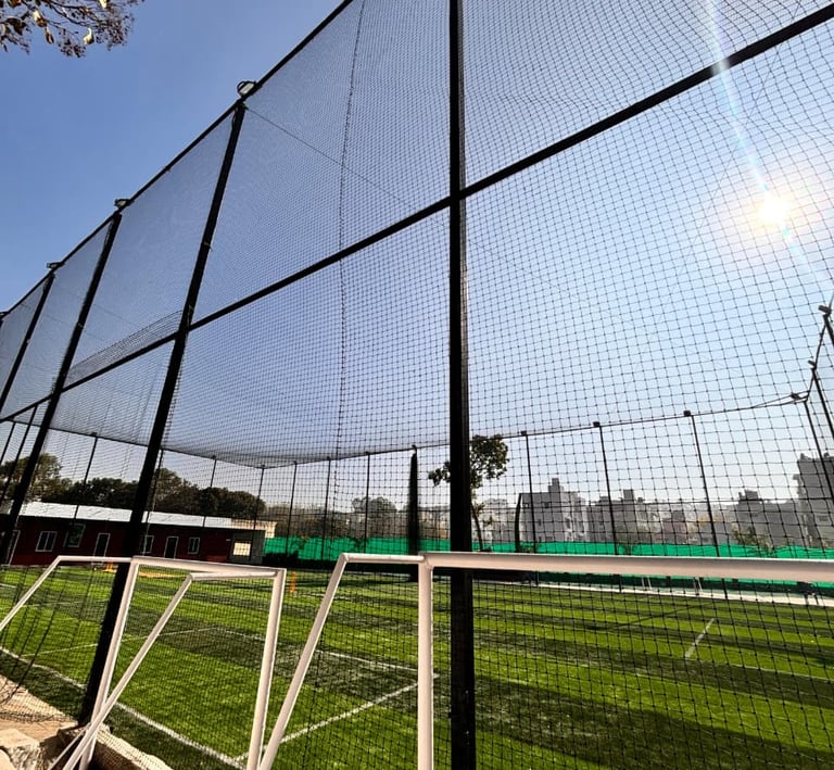 Technicians from Arjilli Enterprises carefully securing a football goal net on a community playgroun
