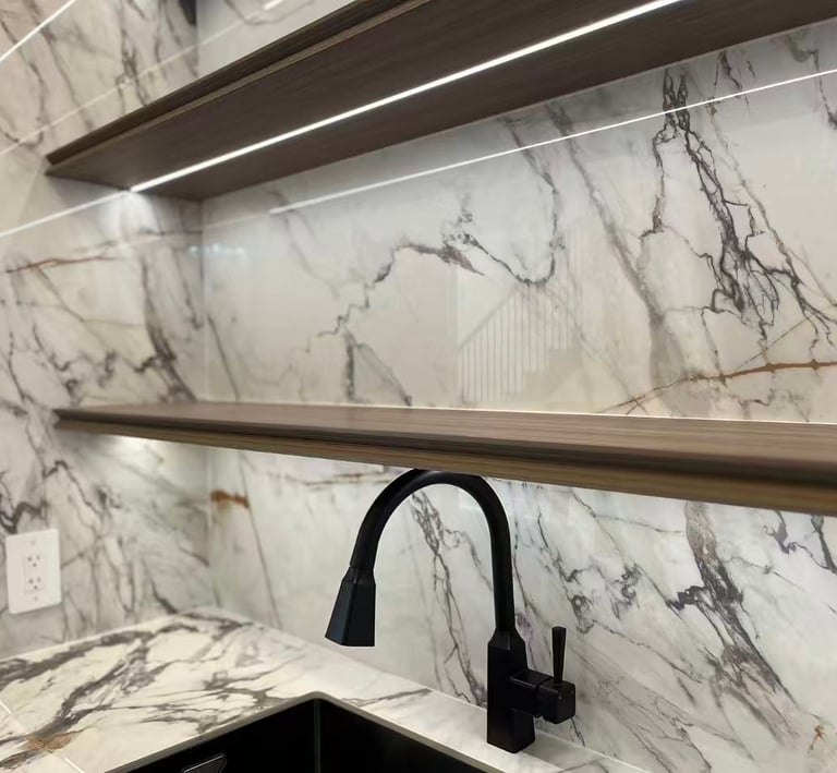 Modern marble kitchen backsplash with floating wooden shelves and integrated LED lighting.