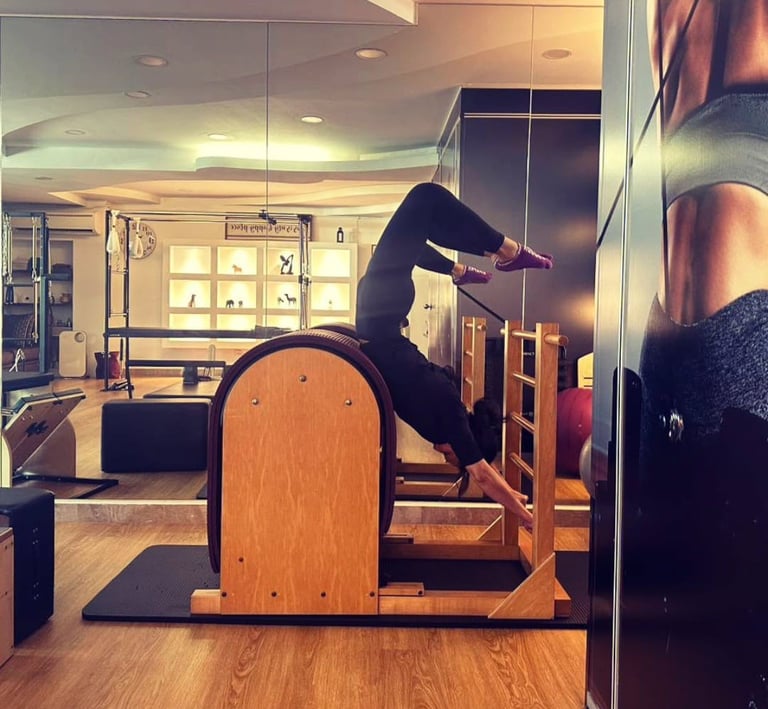 Pilates practioner performing advanced spine extension on ladder barrel at The Pilates Room Bangsar