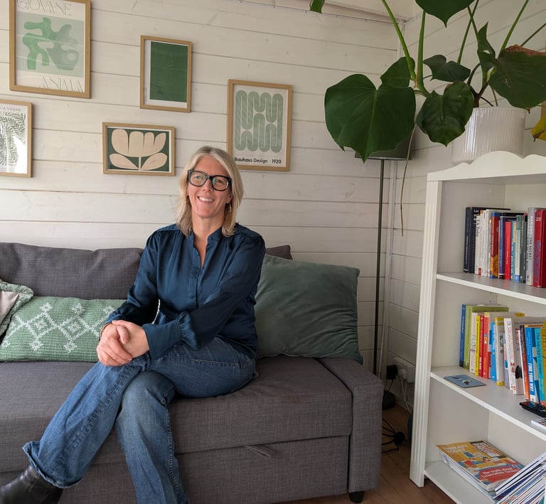 A picture of Alison Zorraquin, Counsellor, sitting on a sofa in the counselling practice