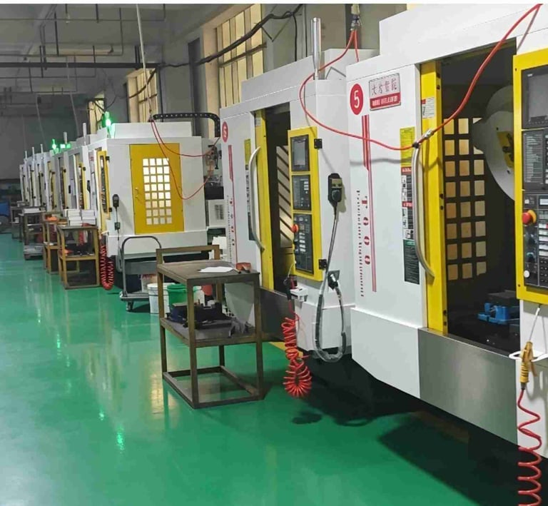 Industrial CNC milling machines lined up in a modern precision manufacturing facility.