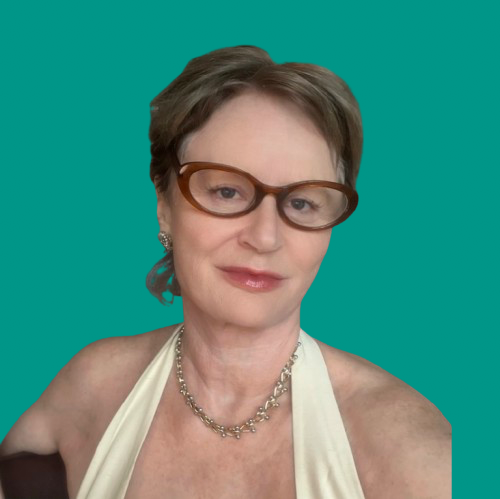 Deb Guy, visibility and embodiment mentor, sitting and smiling warmly.