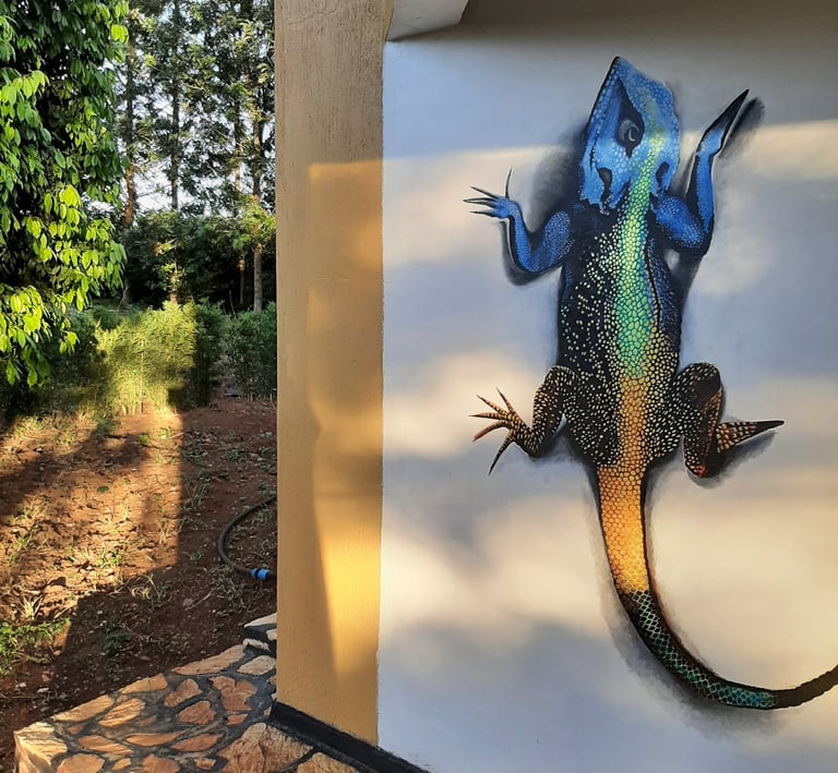 a photograph of an agama lizard painted on a wall.