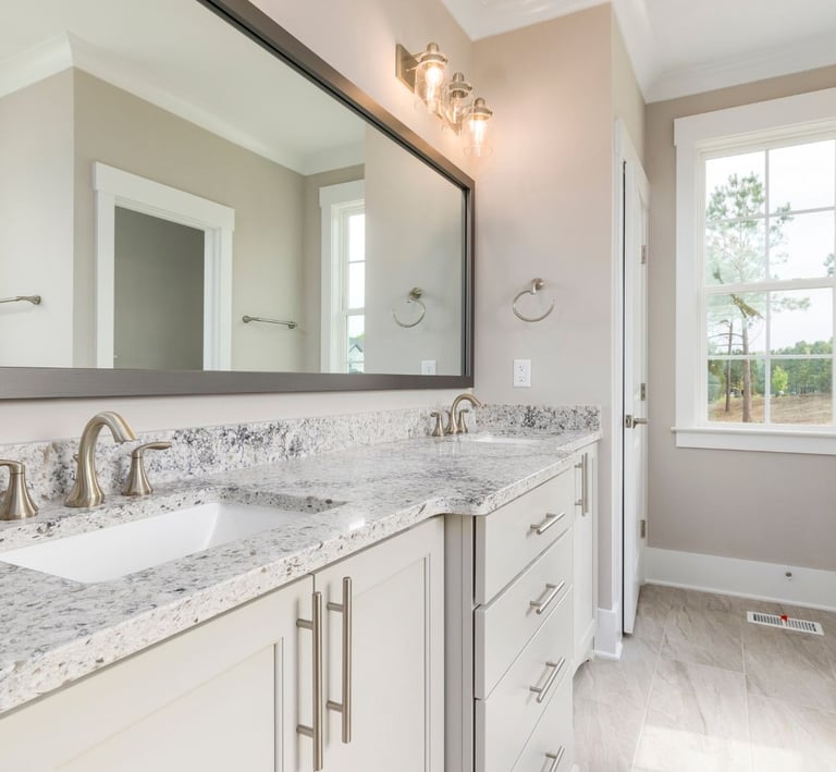 a bathroom with a marble counter top and a mirror