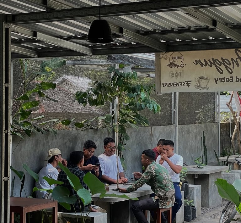 a group of people sitting at a table with food