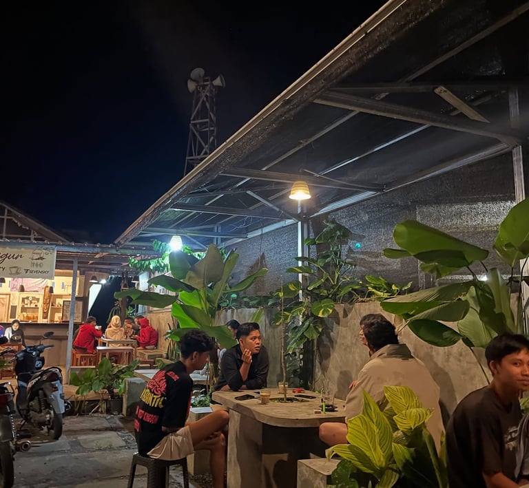 a group of people sitting at a table with food