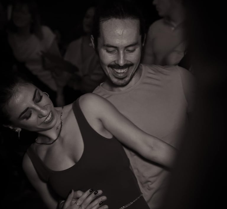 a man and woman dancing at a party